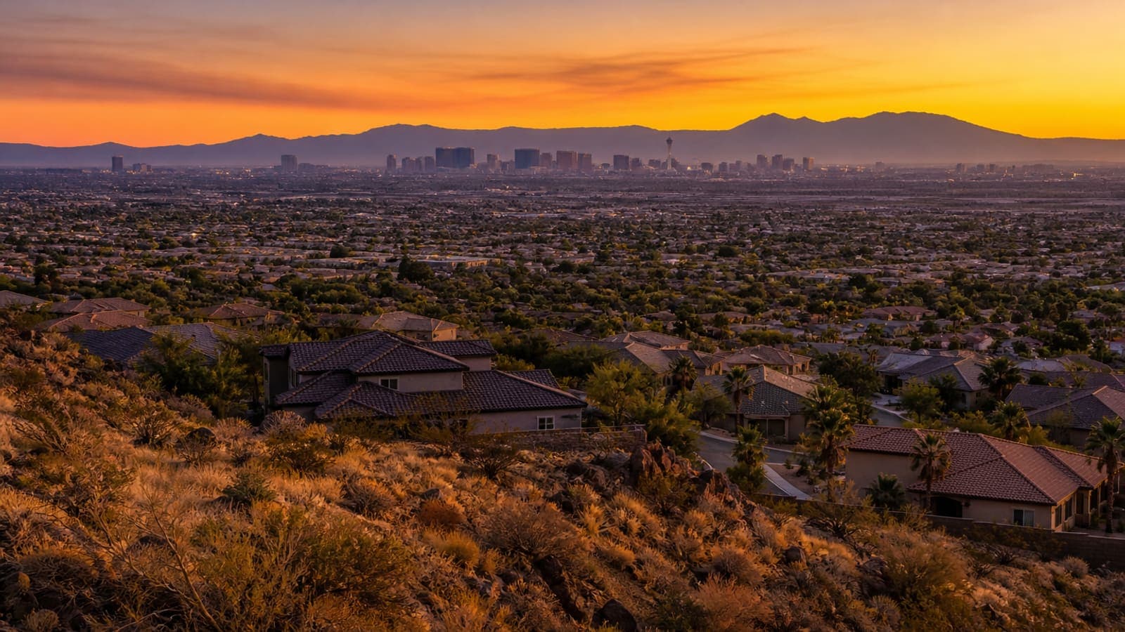 Las Vegas valley at golden hour, from the western foothills toward the Strip skyline
